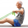 elderly man working out with bands on mat