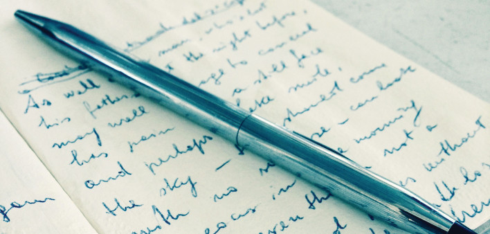 pen and journal with writing