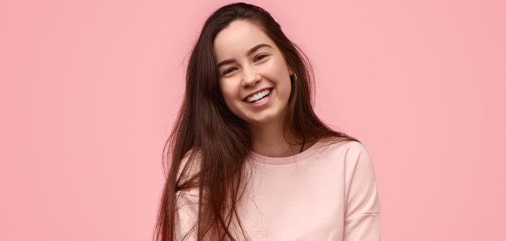 Laughing teenager with folded arms