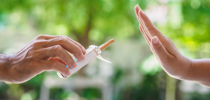 lose up of male hands holding cigarettes and proposing it to person.