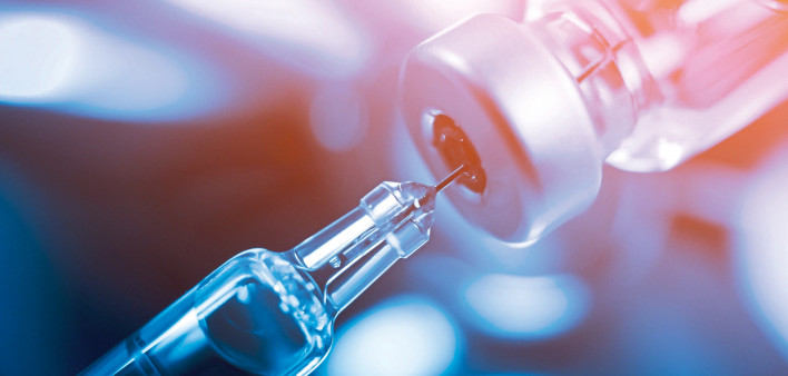 needle going into a vial vaccine medication
