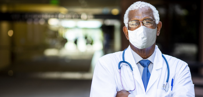 Portrait of a senior African American doctor at the hospital wearing a mask